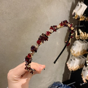 Detail of luxury red crystal beaded headband with handcrafted rhinestones and vintage finish