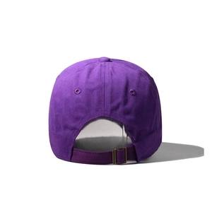 Detail view of adjustable strap with vintage bronze buckle on purple cotton baseball cap
