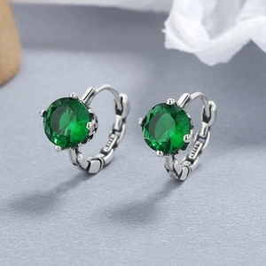 Macro view of S925 sterling silver hoop earrings with round green zircon stones