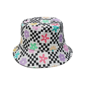 Detail of checkered bucket hat with colorful floral print and durable canvas texture