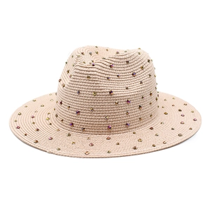 Classic straw Panama hat featuring colorful rhinestones on a beige woven surface