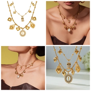Detail of layered gold-plated owl and heart pendant necklace with shimmering 5A zircon