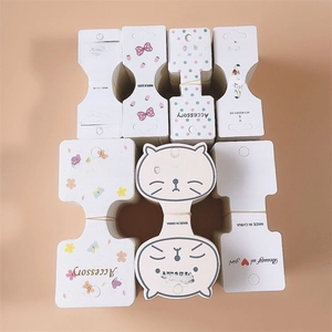 Macro shot of assorted white paper display cards for hair clips and jewelry organization