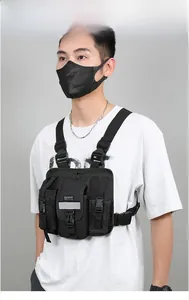 Front view of black tactical chest rig with reflective strips and quick-release buckles