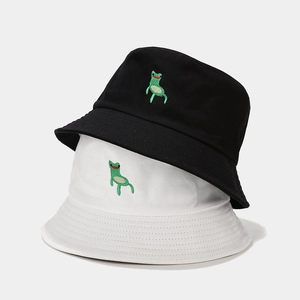 Black and white bucket hats with creative green frog embroidery in a stylish stack