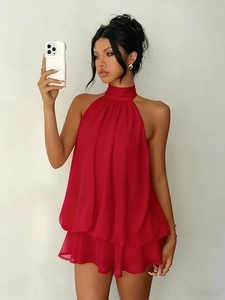 Detail of red halter chiffon dress featuring elegant layered ruffles and tiered skirt