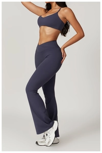 Detail of grey-blue yoga set featuring a V-shaped crossover high waist and flared leg cut
