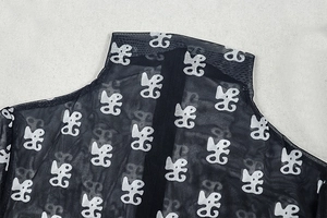 Detail of high neck mesh bodysuit with white print and rear zipper closure