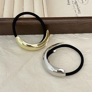 Close-up of minimalist gold and silver crescent metal hair ties with high elastic bands