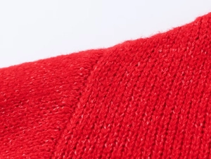 Macro shot of vibrant red knitted sweater detailing tight stitching and fabric texture