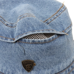Light blue denim bucket hat with a vintage metal badge and breathable mesh vent detail