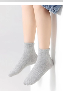 Detail showing the gray ribbed texture and knit fabric of these kids' sports socks