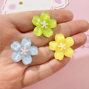 Three-piece set of translucent resin cherry blossom charms in green, yellow, and blue