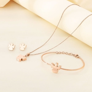 Detailed close-up of rose gold jewelry set including angel necklace, bracelet and earrings