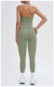 Back view of sage green yoga set featuring a halter open-back top and high-waist leggings