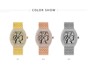 Close-up of three fashion watches in gold, rose gold, and silver with crystal bezel