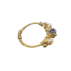 Handmade gold wire wrapped ring with white natural pearl and purple gemstone accents