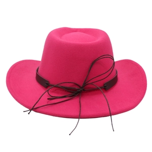 Classic magenta western cowboy felt hat with black ribbon tie on white background