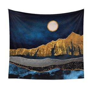 Detail of artistic tapestry featuring golden mountains and a moonlit night sky