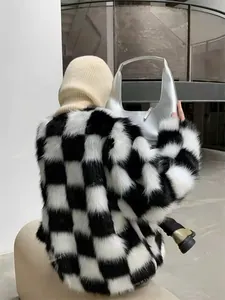 Detail shot of the faux fur jacket's black and white checkerboard texture and plush finish