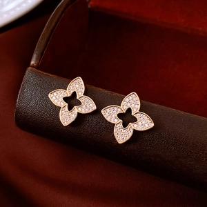 Macro shot of rose gold flower earrings with pavé set cubic zirconia and hollow petals