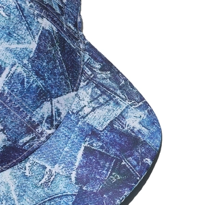 Detail of blue and white abstract print on baseball cap brim with fine stitching