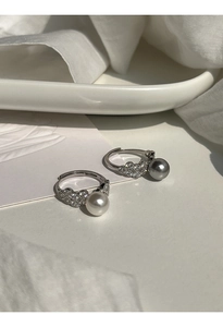 Macro shot of silver lace rings with grey and white pearls and sparkling crystal details