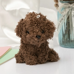 Macro detail of curly dark brown plush dog toy with hanging loop on a cozy background