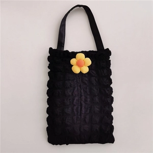 Close-up of black bubble textured fabric car tissue holder with 3D floral decoration