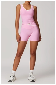 Close-up of pink high-waist cross-waist shorts and V-neck tank top with contrast trim