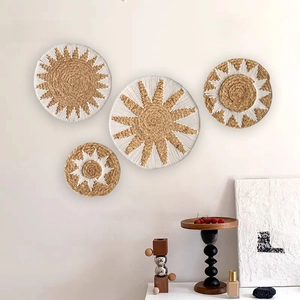 Detail of four woven straw wall hangings with sunburst patterns for boho room decor