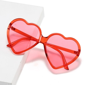Fashionable pink heart-shaped jelly sunglasses with a translucent red plastic frame