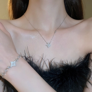 Elegant silver star necklace and bracelet set with sparkling crystals on model
