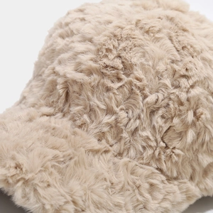 Close-up detail of soft beige plush faux fur texture on this warm winter baseball cap
