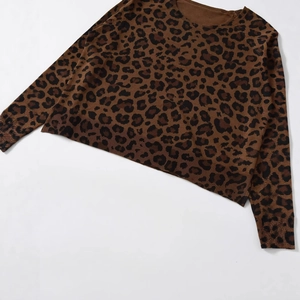 Women's leopard print knit sweater with classic round neck and ribbed cuffs on white background