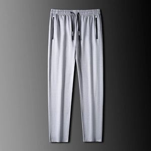Pantalones deportivos grises para hombre con cordón elástico y bolsillos con cremallera