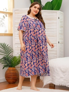 Detail of plus size paisley nightdress featuring white lace trim and bow on the neckline