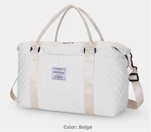 Detail view of large quilted off-white travel bag with adjustable strap and top handles