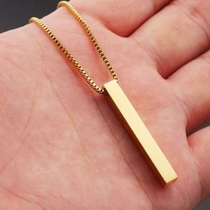 Minimalist gold 3D pillar pendant necklace on box chain held in hand for men and women