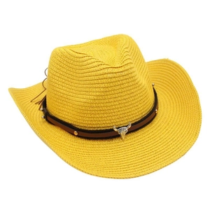 Detail of yellow straw cowboy hat with leather band, studs and silver bull skull ornament