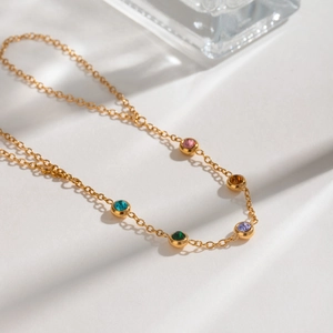 Minimalist gold stainless steel finger chain bracelet featuring five colored round gemstones