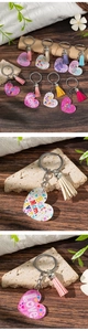 Detail view of colorful acrylic heart keychains with tassels on a natural wood surface