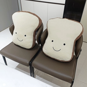 Detail of soft toast plush cushion showing smiley face and fluffy bread slice texture