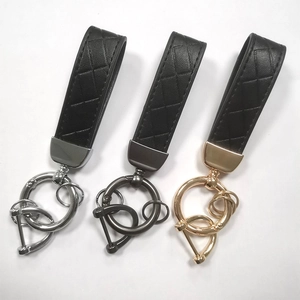 Three premium braided leather keychains in black with gold, silver, and gunmetal hardware