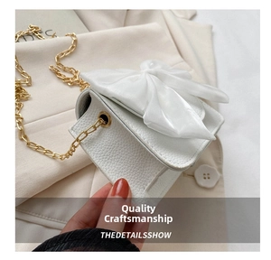 White mini crossbody bag with chic bow and gold chain strap, sweet and stylish design.