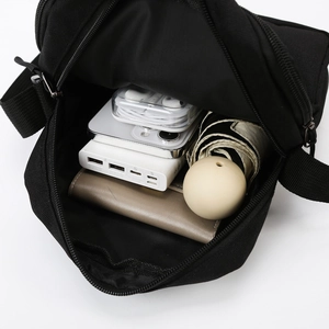 Men's black crossbody bag with organized interior compartments for daily essentials