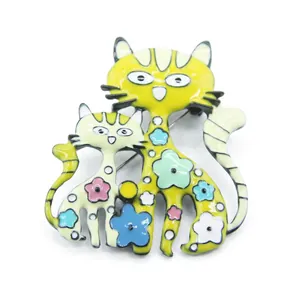 Cartoon cat brooches set with colorful floral enamel details on white background