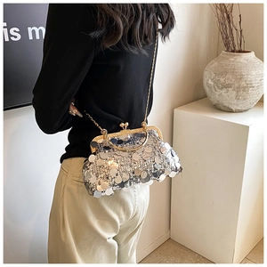 Detail view of a silver sequin evening bag with gold kiss-lock and metal chain strap