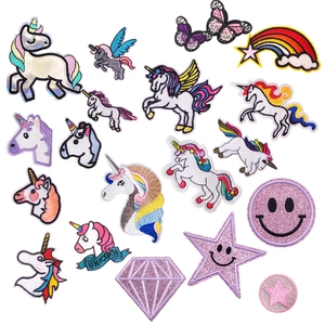 Detailed flat lay of colorful embroidered unicorn and rainbow patches for kids clothing