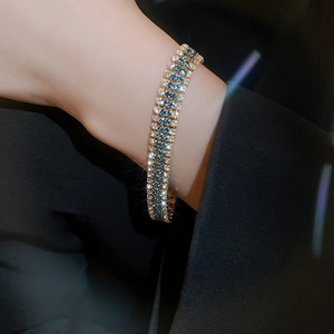 Detail of vintage luxury bracelet featuring blue and white zircon stones on wrist